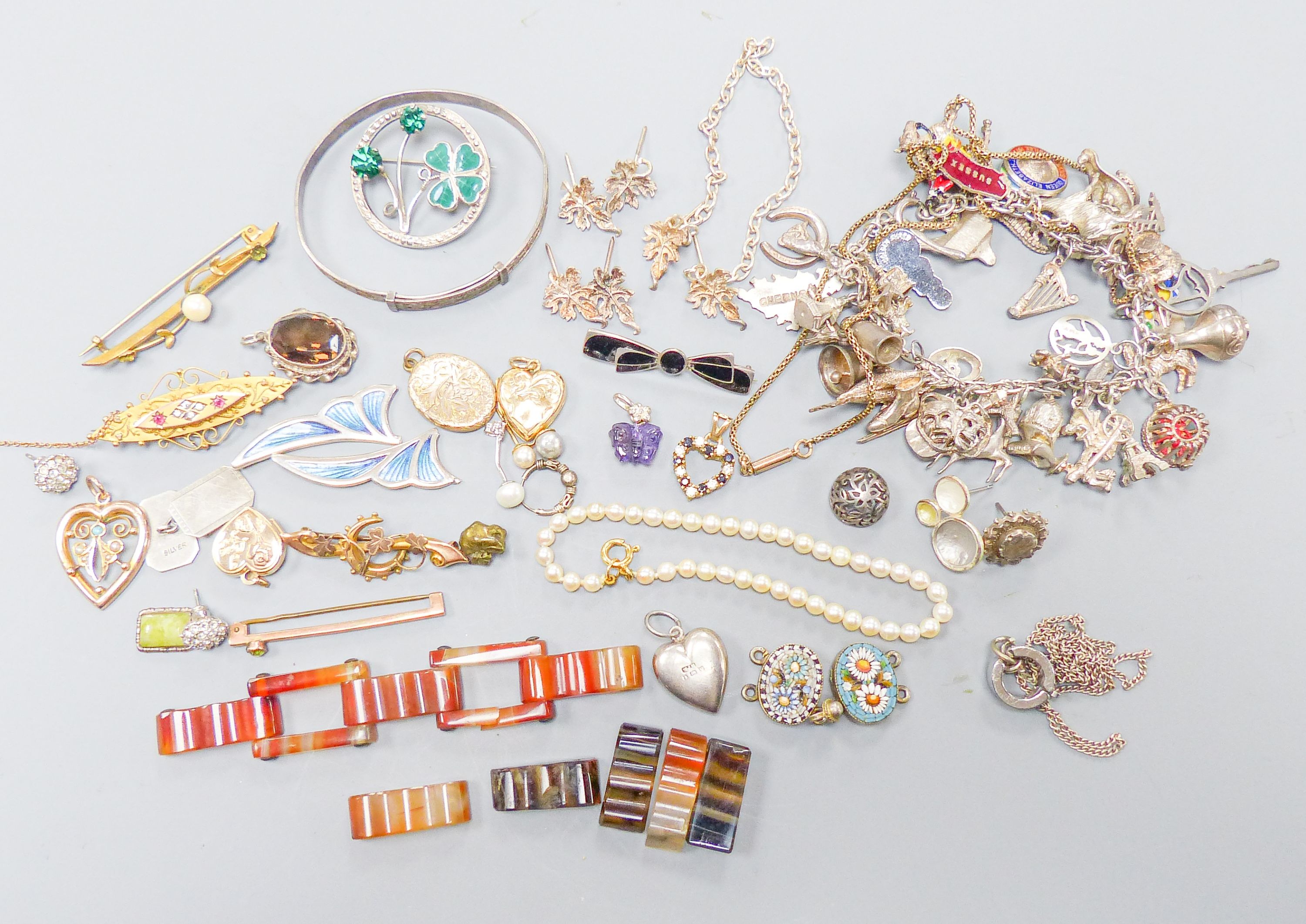 Assorted gold and silver jewellery including bar brooches, charm bracelet etc.